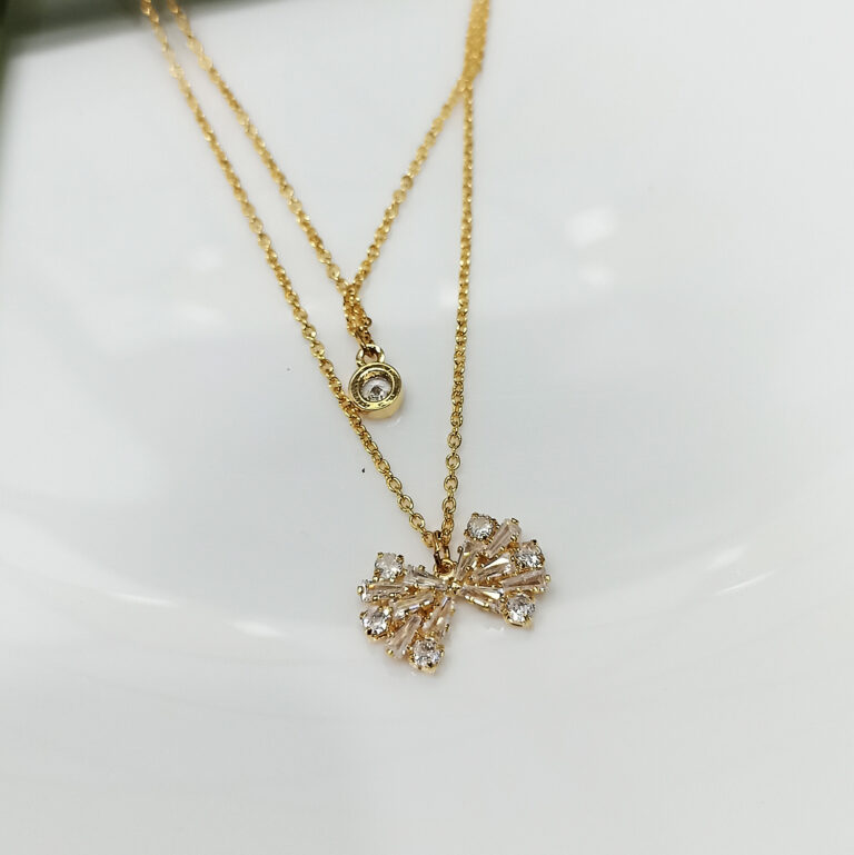 Layered Gold Necklace with Sparkling Bow and Solitaire Zircon Pendants