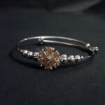 Silver-Toned Adjustable Bangle with Gemstone Flower